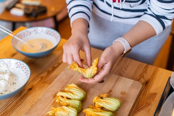 stock image Preparing zucchini flowers stuffed with ricotta cheese, woman's hand shown