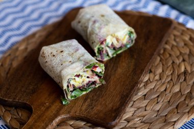 Vegetarian Wraps with beetroot, red cabbage, arugula and humus  clipart