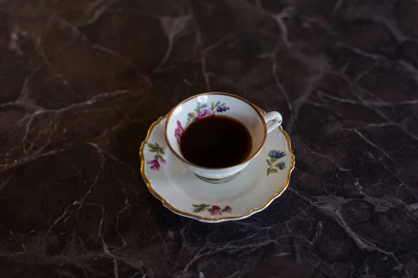 Black coffee served in an elegant, old china. — Stock Photo, Image