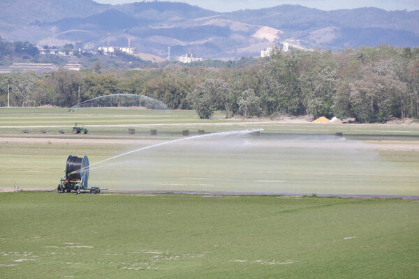Tractors and irrigation systems work in sync, showcasing the power of modern farming, technology in the field, and the importance of sustainable food production for the future.