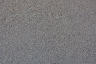 Bütün kare içinde küçük gri taş olan beton duvar