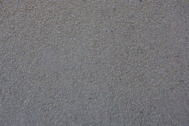 Bütün kare içinde küçük gri taş olan beton duvar