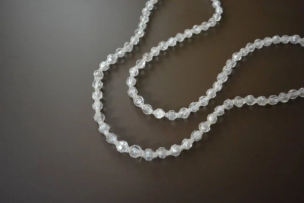 Female Gray Plastic Beads Brown Matte Background — ストック写真