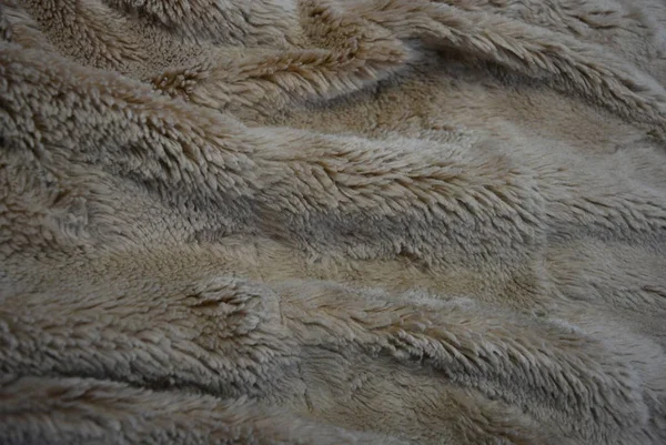 Interesting material, soft brown gray fur covers, linen with long coats and with its structure in the form of natural fur