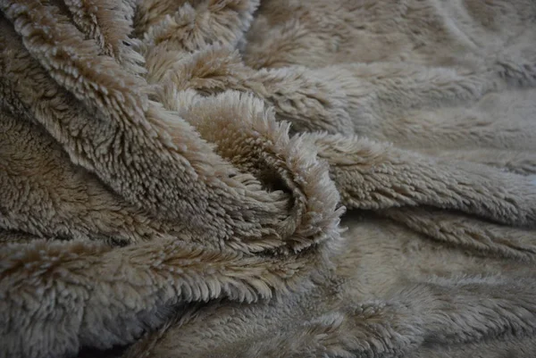 Interesting material, soft brown gray fur covers, linen with long coats and with its structure in the form of natural fur