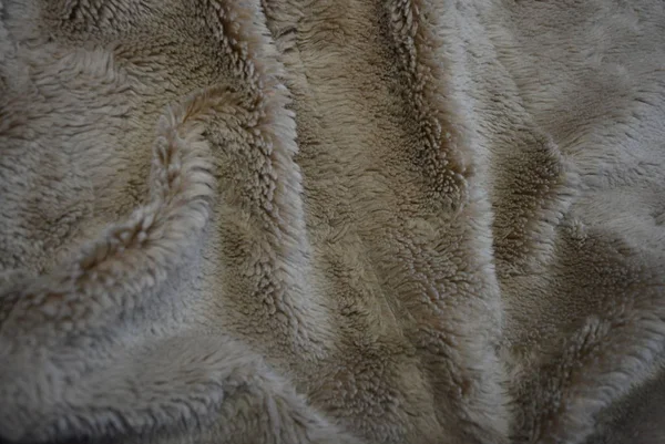 Interesting material, soft brown gray fur covers, linen with long coats and with its structure in the form of natural fur