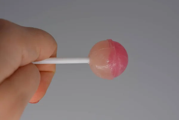 Female Hand Sweet Strawberry Candy Sucking Candy White Plastic Stick — Stock Photo, Image