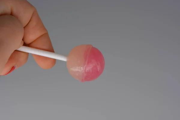 Female Hand Sweet Strawberry Candy Sucking Candy White Plastic Stick — Stock Photo, Image