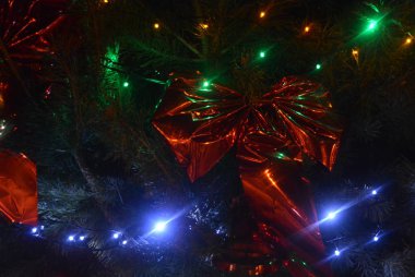 Beautiful Christmas tree, natural pine with red, blue, green and yellow LED bulbs, beautiful balls, toys. New Year's holidays, Christmas and New Year