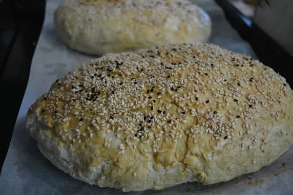 Delicious homemade white bread made according to your recipe. Crisp fresh bread with white sesame seeds and black cumin seeds.