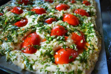 Kırmızı af, yeşil dereotu ve sarımsak taze parçaları ile ciabattna için çiğ hamur hazırlanması.