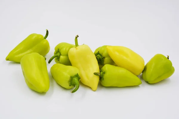 Fresh yellow and green bell peppers, not hot sad peppers are arranged on a white background. Vegetables that grow in Ukraine, healthy and wholesome food for every day.