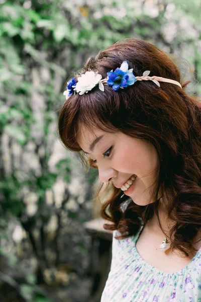 Young pretty Asian woman with flower headband.