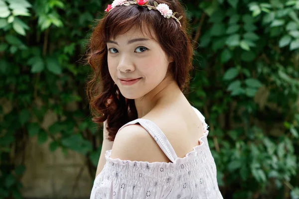 Young pretty Asian woman with flower headband.