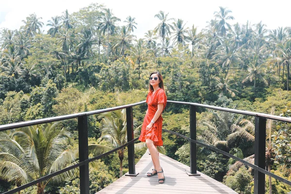 Young pretty Asian woman is standing with mountain view, Ubud, B