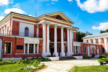 Sütunlu yenilenmiş tarihi bir bina. Güneşli bir günde eski malikane.