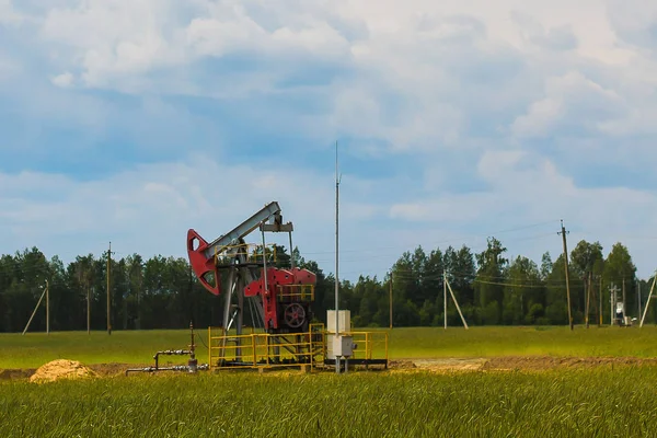 Oil production - oil rig and crane in the field