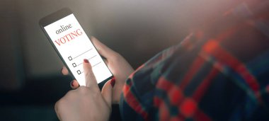  Kadın telefonu kullanarak internet üzerinden oy veriyor. Oy kullanma ve seçim konsepti. Metin için yer