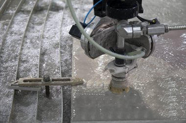 The water jet machine cutting the aluminum plate.The modern manufacturing process. clipart