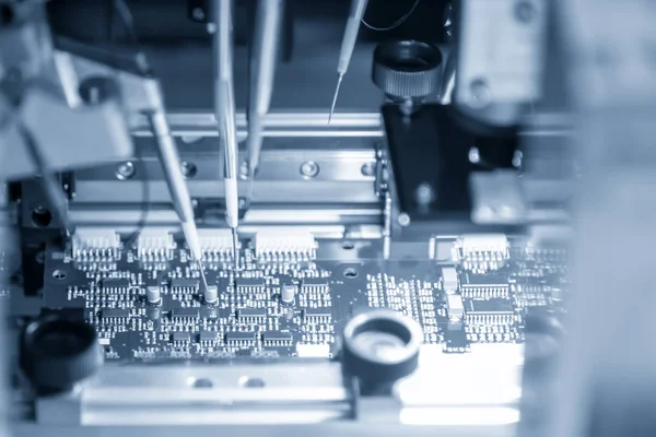 The production line of electronic board with microchip in the light blue scene.The electronics board production process.