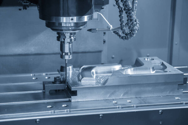 The vertical CNC milling machine attach the CMM probe in the light blue scene. High  technology manufacturing process.
