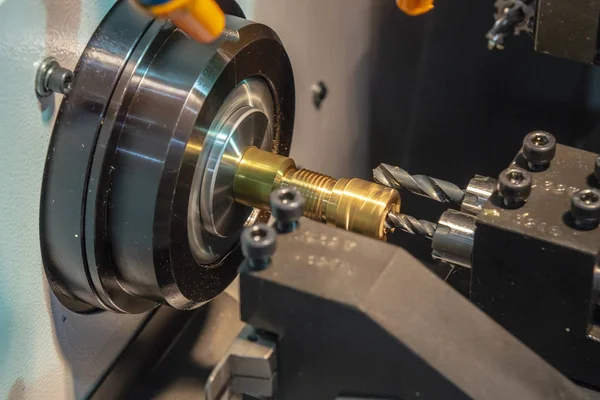 The CNC lathe machine drilling the hole at the brass shaft. — Stock Photo, Image