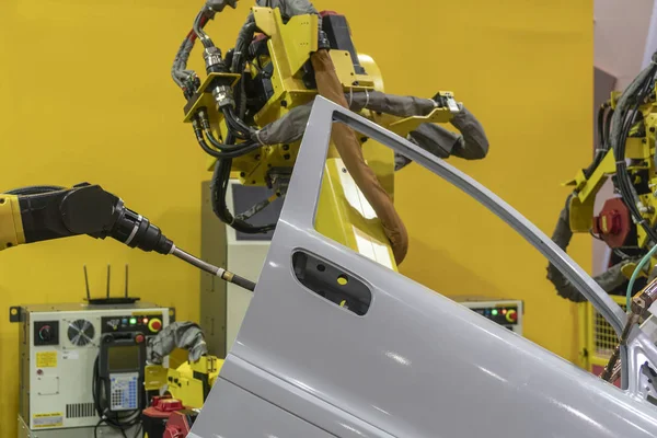 The spot welding the automotive parts by  the robotic arm.