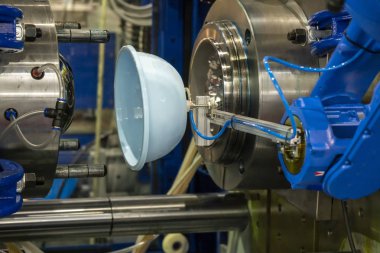 Robotik kol plastik parçaları enjeksiyondan uzağa taşır.