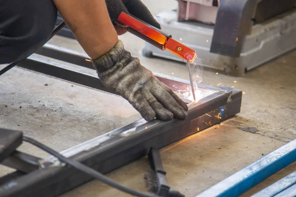 The skill worker use the electric welding machine .