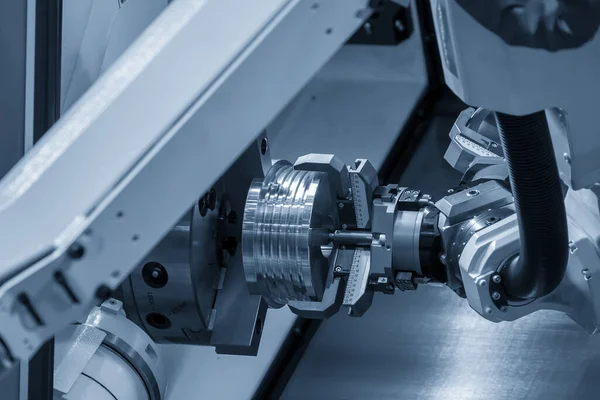 The hi-technology CNC lathe machine operation with gripping robotic system.The cobot  operation concept in automotive parts manufacturing process by robotic system.