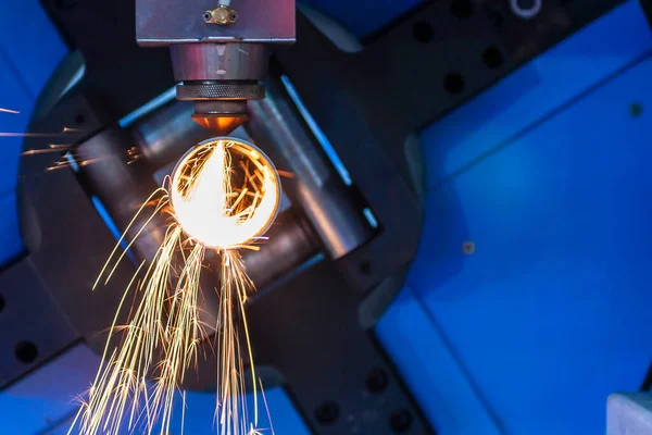 The fiber laser cutting machine cutting the metal pipe .The hi-technology metal working process by laser cutting machine.