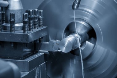 Torna makinesi, metal şaft parçalarını kesme aletleriyle kesiyor. Makineyi döndürerek metal işleme süreci.