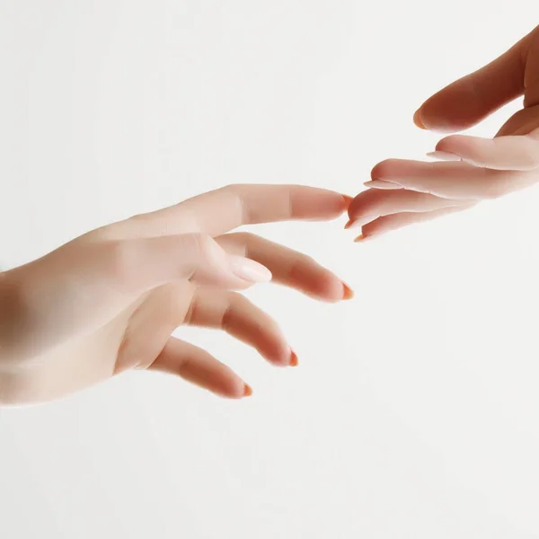 Hand skin care. Closeup of beautiful woman hands with light manicure on nails . Cream for hands and treatment.