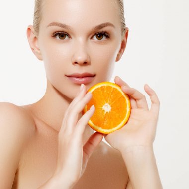 Taze meyve ile gülümseyen kız. Güzellik modeli sulu portakal alır. Çiller ile neşeli kız. Sağlıklı bir diyet kavramı. Profesyonel makyaj. Portakal dilim