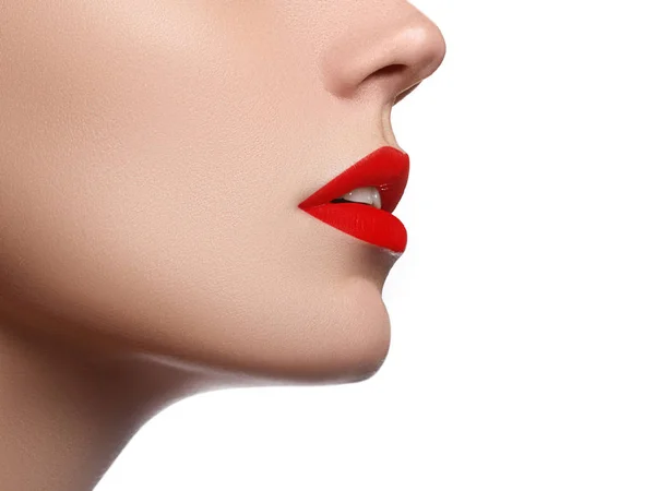 Cosmetics, makeup and trends. Bright lip gloss and lipstick on lips. Closeup of beautiful female mouth with red lip makeup. Beautiful part of female face. Perfect clean skin — Stock Photo, Image