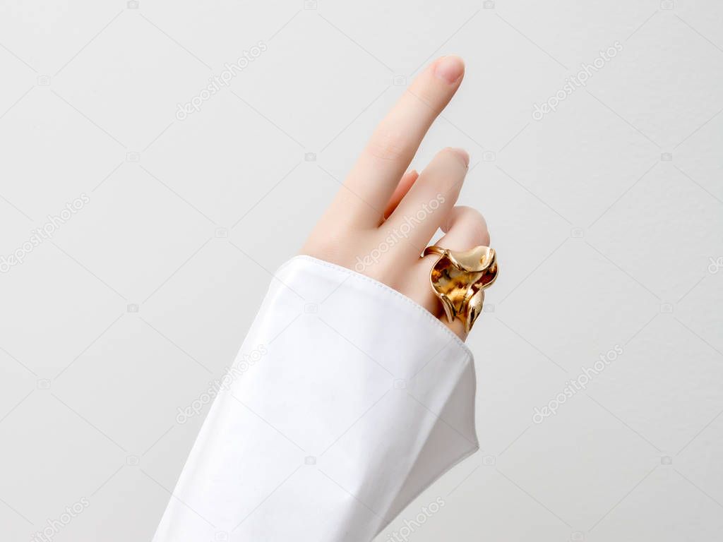 Simple beauty concept - jewelry accessories . Beauty delicate hands with manicure close up . Beautiful female fingers with manicure and fashionable gold ring . Minimalistic fashion photography