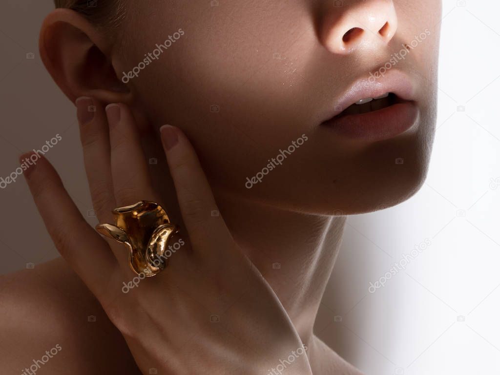 Beautiful model girl with pearl earrings . Fashion makeup and cosmetics . Big earrings and gold ring jewelry . Natural clean skin look . Beauty and fashion store concept