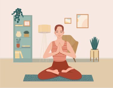 Bacak bacak üstüne atmış tatlı bir kız evde yoga yapıyor..