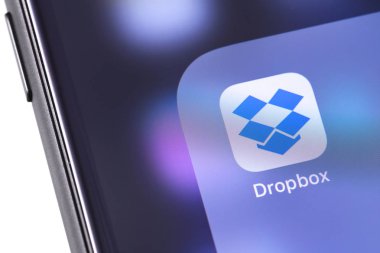 Dropbox icon app on the screen smartphone. Dropbox is a service that gives you access to images, documents and videos online from anywhere. Moscow, Russia - October 14, 2018 clipart