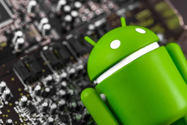 Closeup Google Android figure and circuit board. — Stok Foto