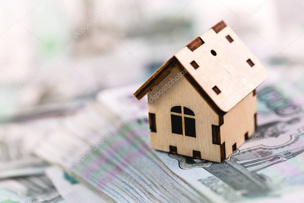 Russian banknotes rubles under wooden house symbol