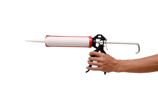 Férfi kéztároló tömítés pisztoly és fehér szilikon tömítőanyag — Stock Fotó
