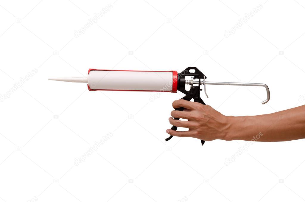 Men's hand holding Caulking gun and white silicone sealant