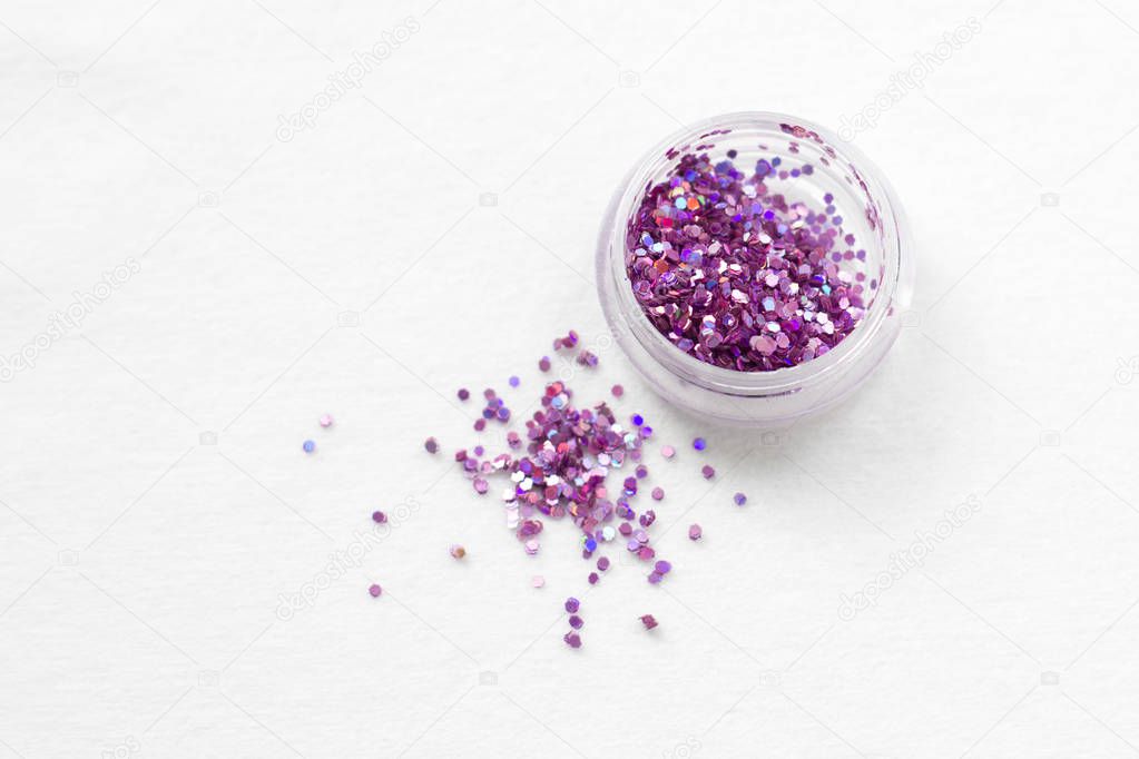 Glitter and sequins for nail design and makeup. decorations for fashion and beauty. Jars with decor