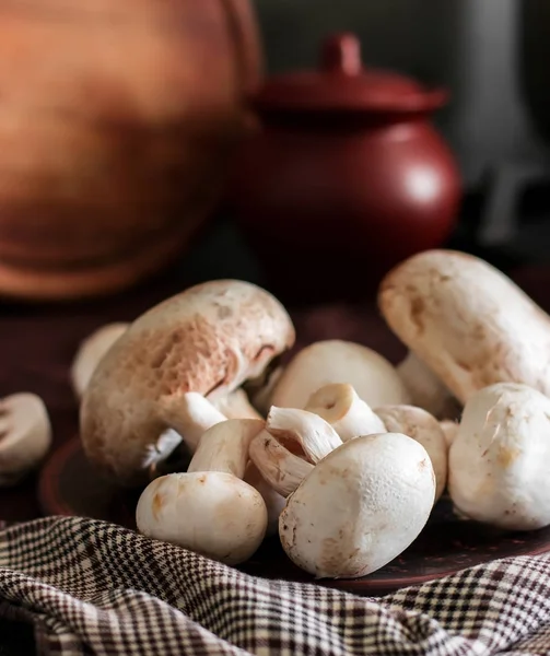 Fresh champignon mushrooms group on the table. Fresh vegetables — Stock Image Fresh champignon mushrooms group on the table. Fresh vegetables Royalty Free Stock Images