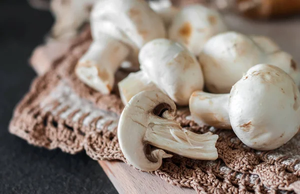 Fresh champignon mushrooms group on the table. Fresh vegetables — Stock Image Fresh champignon mushrooms group on the table. Fresh vegetables Stock Photo