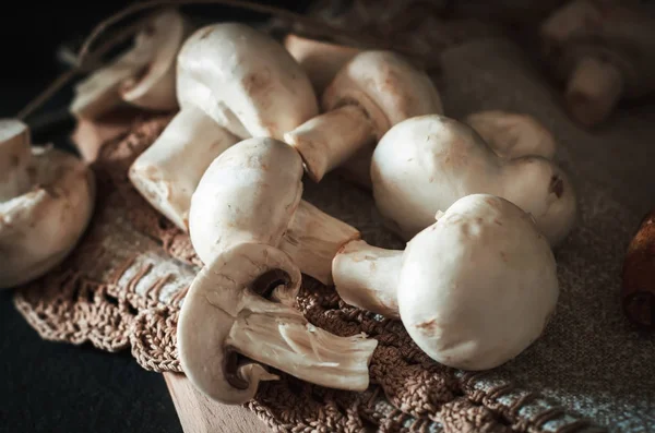 Fresh champignon mushrooms group on the table. Fresh vegetables — Stock Image Fresh champignon mushrooms group on the table. Fresh vegetables Stock Image