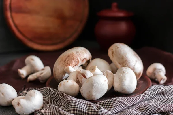 Fresh champignon mushrooms group on the table. Fresh vegetables Royalty Free Stock Images