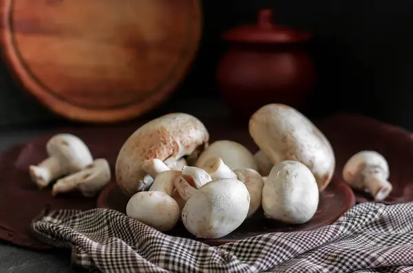 Fresh champignon mushrooms group on the table. Fresh vegetables — Stock Image Fresh champignon mushrooms group on the table. Fresh vegetables Royalty Free Stock Images