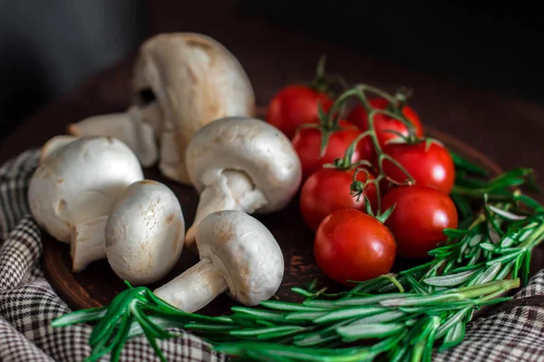 Fresh cherry tomatoes, sprigs of rosemary and champignon mushroo — Stock Image Fresh cherry tomatoes, sprigs of rosemary and champignon mushroo Stock Photo